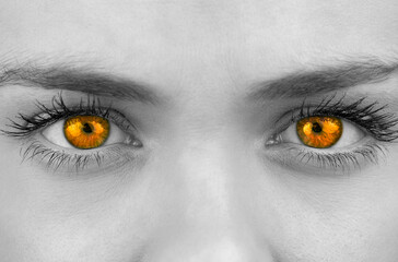 Bright orange eyes on female face