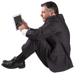Mature businessman sitting using tablet