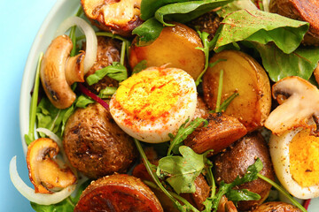 Plate of tasty potato salad with eggs and mushrooms, closeup