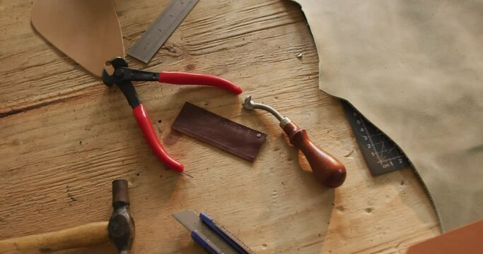 Close up of tools lying on table in leather workshop
