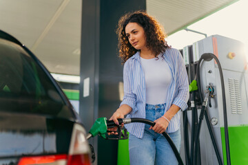 A student puts fuel in his car before leaving home for college
