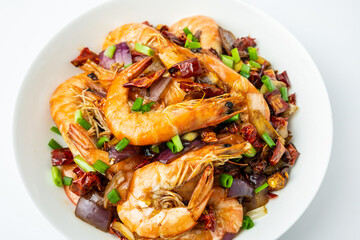 A plate of spicy shrimp on a white background