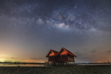 The couple of house with a Milky Way on Thailand