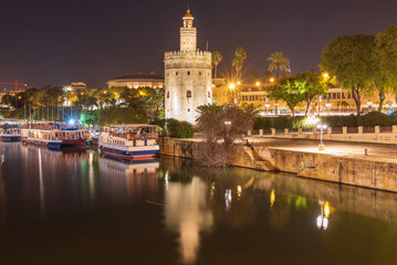 Fototapeta na wymiar The Torre del Oro Tower of Gold is a dodecagonal military watchtower in Seville southern Spain It was erected in order to control access to city via the Guadalquivir river.