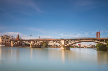 Triana Bridge is a metal arch bridge in Seville Spain that connects the Triana neighbourhood with the centre of the city