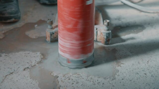 4K video of drilling a hole into a concrete floor with core driller
