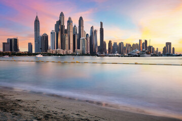 Dubai skyline Marina with reflecion at colorful sunset, UEA