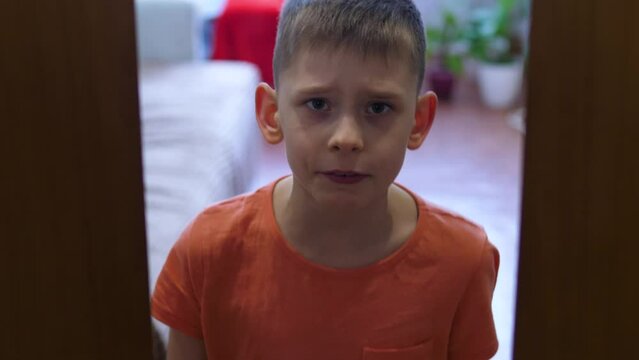 Angry boy closes the door to his room. The child does not let the parents into the room. Problems of upbringing, the conquest of personal space by children. A quarrel in a family with children