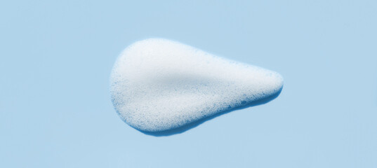 texture foam mousse foam cosmetic smear sample on blue background