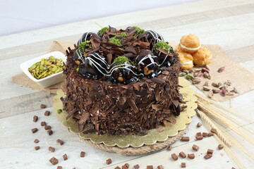 chocolate cake with profiterole and pistachio