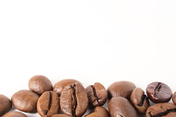 close-up of a pile of natural roasted coffee beans isolated on white background and copy space