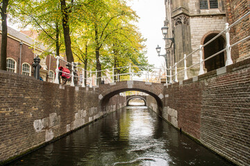 The Netherlands, Delft, October 2022. The narrowest canal in Delft. Two old bridges
