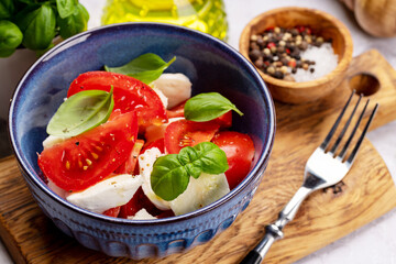Caprese salad with ripe tomatoes, mozzarella and garden basil