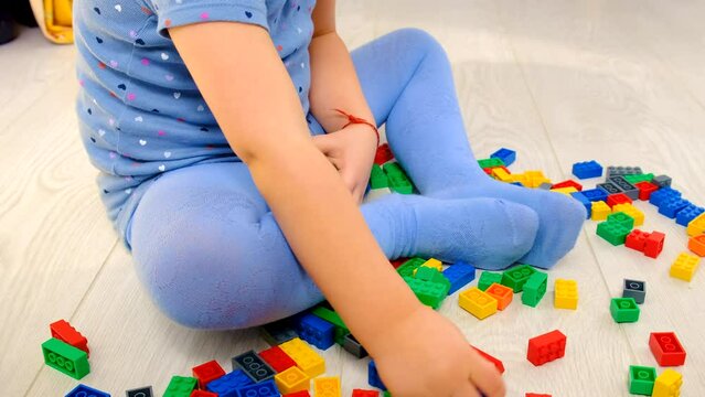 Constructor child plays in the room. Selective focus.