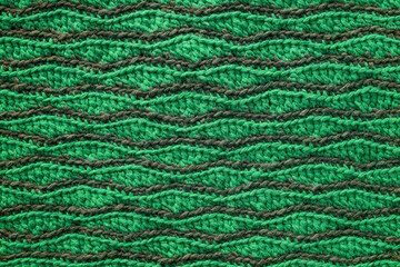 Green grey crocheted wave pattern. Knitted texture.