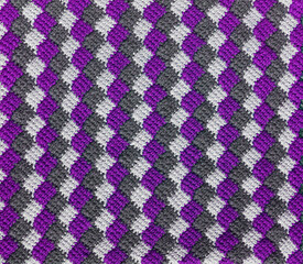 Purple white grey knitted background. Crochet tunisain entrelac.