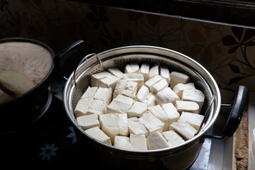 white tofu in a stainless steel pot. Tofu is a food made from the coagulation of coagulated soy bean juice. Tofu originates from China. Tahu.