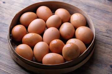 chicken eggs in the woven bamboo container. animal protein. allergen. telur ayam. 