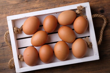 Boiled chicken eggs on a white wooden cutting board. source of animal protein. telur rebus. egg in white box. 