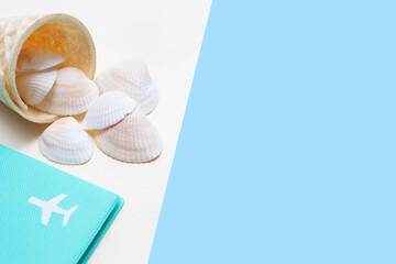 Flat lay on the theme of summer and beach holidays. Airplane and ice cream cone with seashells....