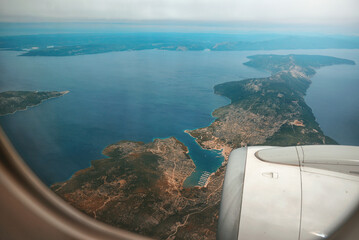 Aerial view through porthole of aircraft, flying over Thessaloniki,Croatia,Istria,Europe.View from airplane .Traveling concept background - 588681599