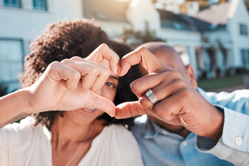 Love, couple and heart hands outside of new house, property or real estate success. Emoji, shape and woman with man in front of dream home in celebration of rental, moving or homeowner milestone