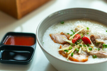 Close up Rice porridge ,congee with minced pork and ginger in white bowl
