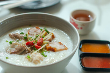 Close up Rice porridge ,congee with minced pork and ginger in white bowl