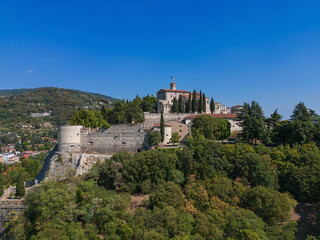 Fototapeta na wymiar Beautiful drone view of the old castle with park on the hill (colle Cidneo) in the Brescia town. Lombardy, Italy