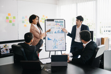 Asian business people sum up the results of their work in the company during the year, new project in office