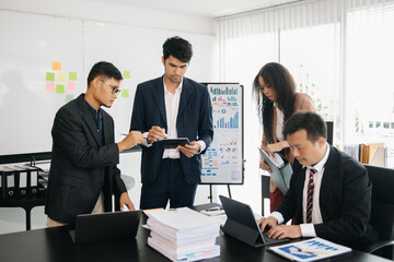 Asian business people sum up the results of their work in the company during the year, new project in office