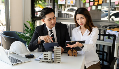 Real estate broker agent presenting and consult to customer to decision making sign insurance form agreement, home model, concerning mortgage loan offer in office