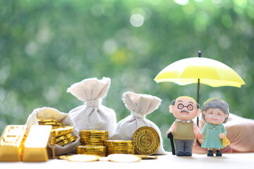 Mutual fund,Love couple senior and hand holding the umbrella with gold coin money in the bag on...
