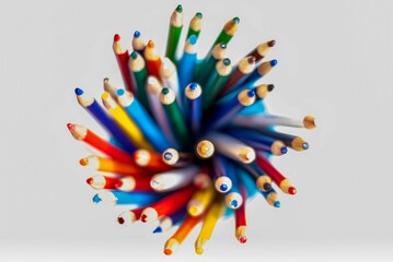 Top view closeup of sharpened pencils of different colors on a white background