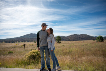 Young wedding couple in love together on the mountain plain