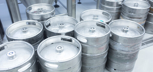 drink production factory, metal kegs on the floor in warehouse