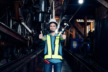 Portrait of female automation engineer standing and looking camera in industrial factory. 