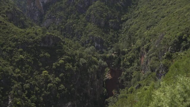Landscape of hills covered in forests in Akchour on a sunny day in Morocco