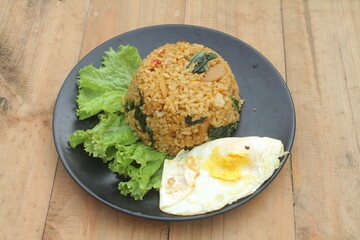 Vegetable fried rice topped with sunny side up eggs

