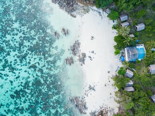 Top view of Sanom Beach with green trees on Ko Lipe island in Thailand surrounded by the blue sea