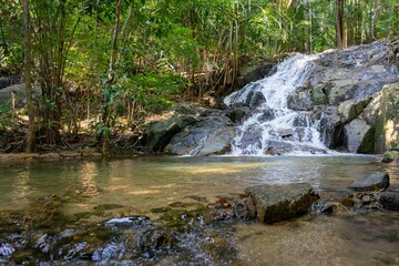Foamy Pirate Waterfall in Koh Adang Thailand surrounded by the green trees during the daytime