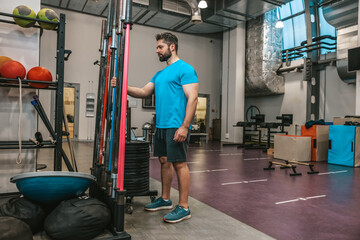 Fototapeta na wymiar Man in sportswear exercising in a gym