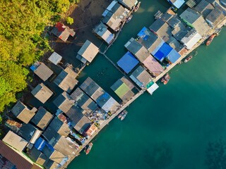 Top view of the Ao Salat floating fishing village on the sea in Thailand during the daytime © Nicola78/Wirestock Creators