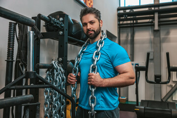 Fototapeta na wymiar Sportsman working with heavy weights in a gym
