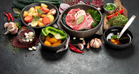 Metal spoon and food ingredients on dark background. Health cooking concept.