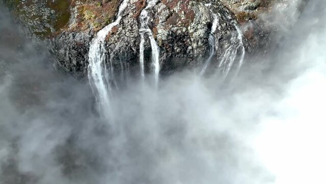 Aerial view of natural scenery of Hydnefossen waterfall falling from rocky cliffs in Hemsedal Norway