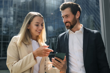 Colleagues discussing something and looking inloved and contented