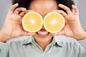 Lemon eyes, health and face of black woman in studio for nutrition, wellness and healthy snack. Food, diet and girl smile with organic fruit for detox, vitamins and weight loss on white background