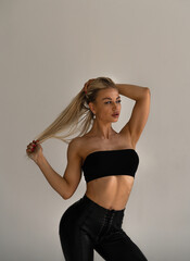 Obraz premium portrait of a beautiful blonde girl on a white background. Model sports appearance