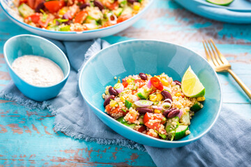 Mexican quinoa black bean salad with fresh tomatoes, cucumbers, onion and cilantro